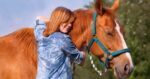 Woman hugging chestnut horse. The power of change